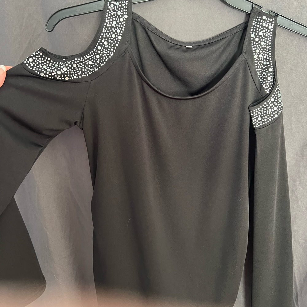 Long black top, stretchy material. Adorable with leggings. Runs small.